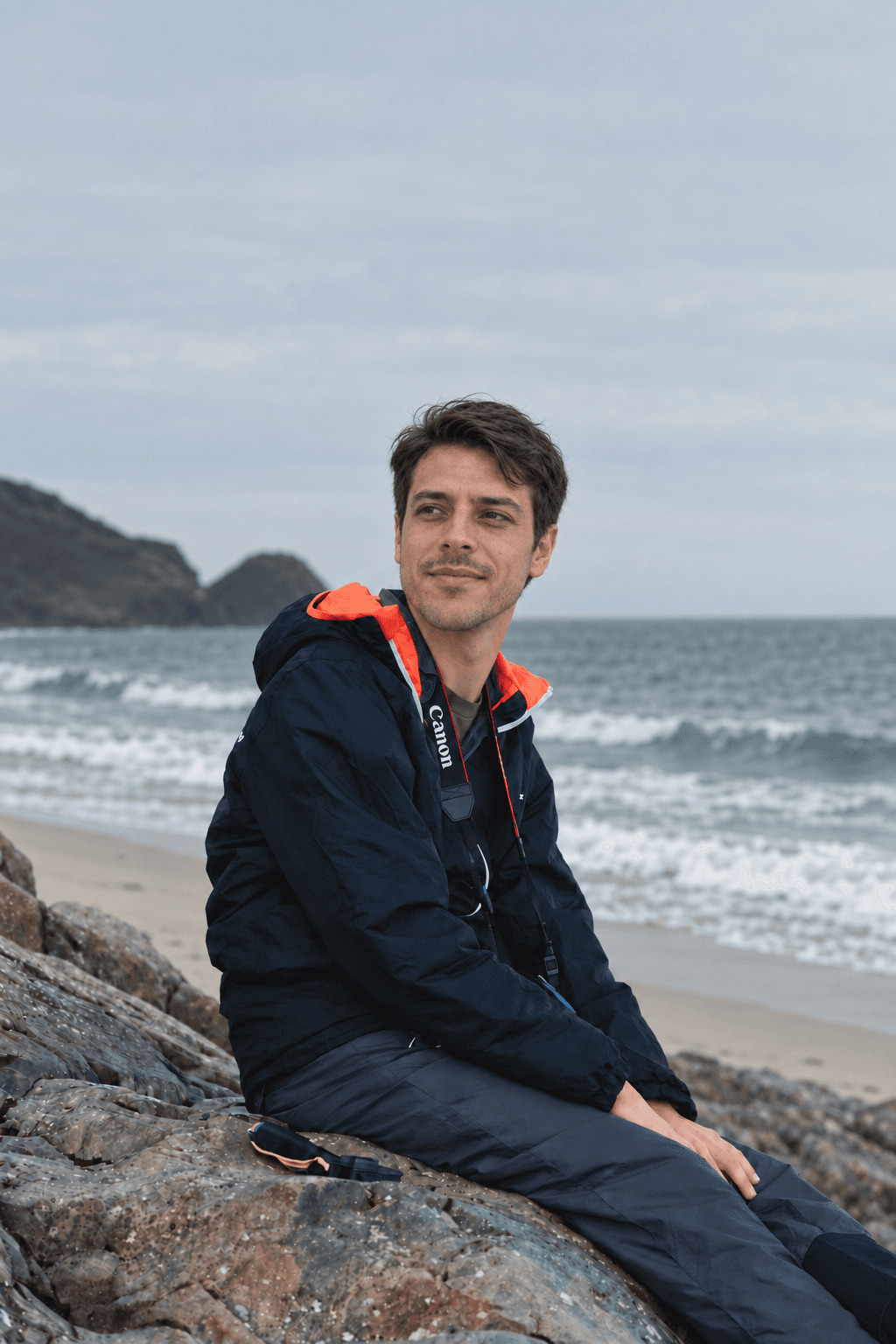Illustrative AI composite of a look-alike Luis seated at a coast